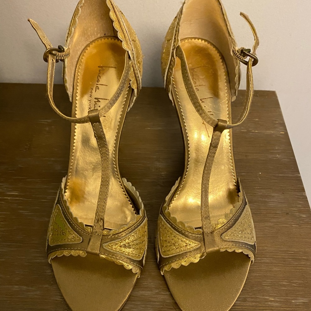 Nicole Miller gold t-strap sandal.